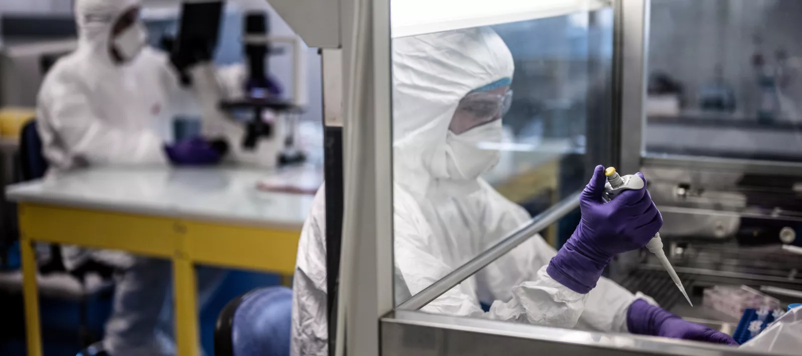 Two medical specialist in full equipment work in a laboratory