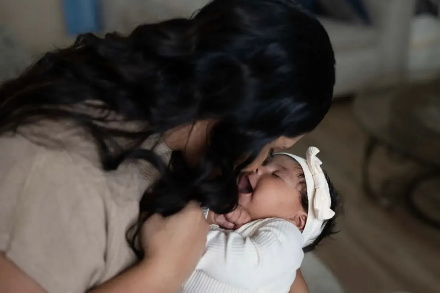 mother sits holding baby
