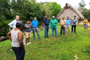 a group of people stand observing the water