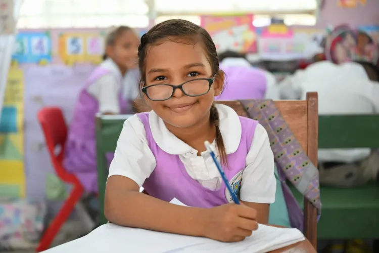 girl sitting at desk in classroom