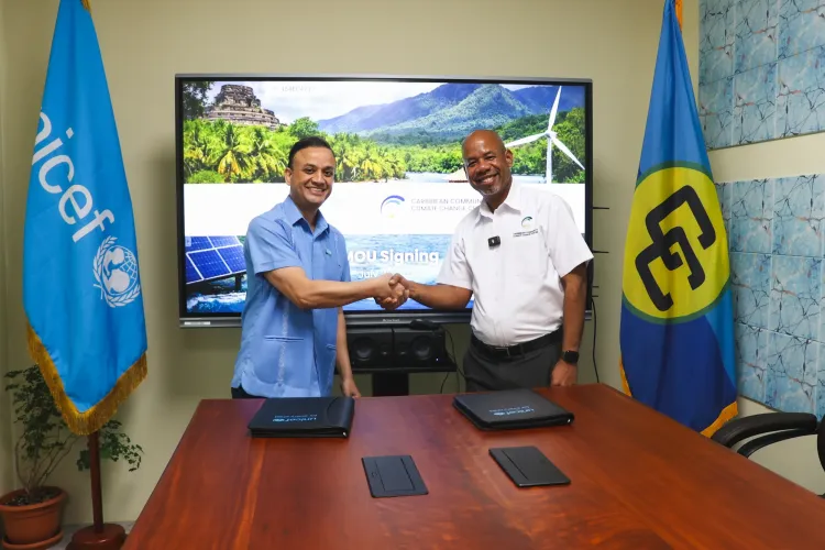 two men pose with hand shake