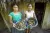 Two teen girls stand holding bowls of tamales