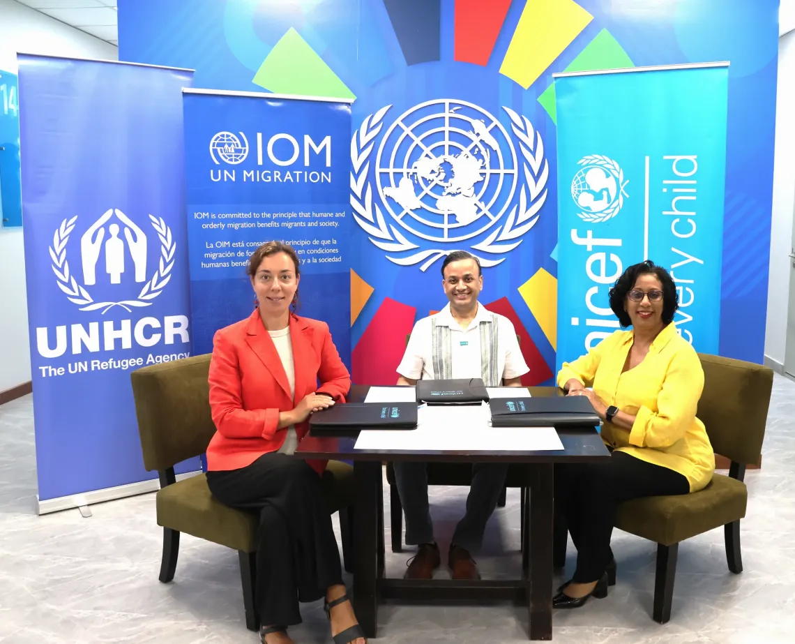 Participants pose for group photo while signing official document