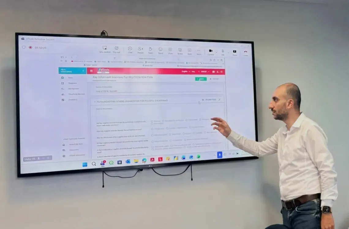 Man stand pointing to screen 