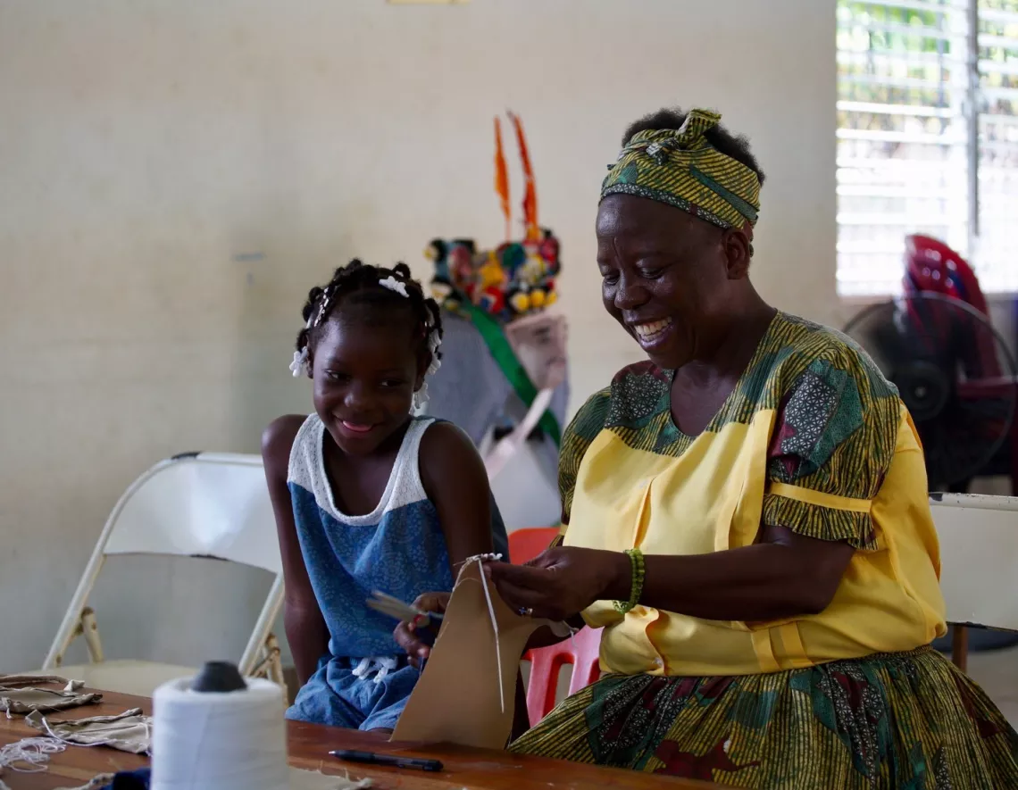 A Garifuna elder passing down her knowledge of Jonkunnu costume making to the next generation. 