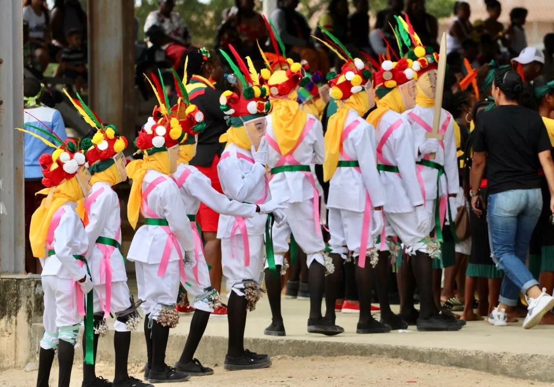A group of dancers prepares to enter the auditorium at the Junior Jonkunnu competition in Dangriga. 