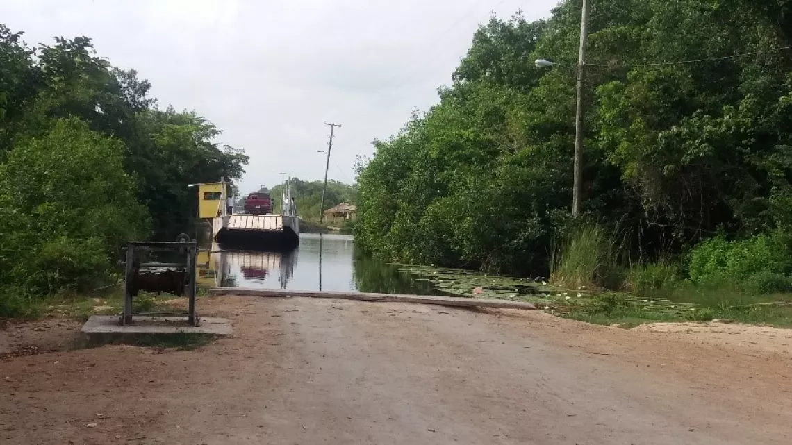 Men operating the hand cranked ferry crossing &ndash; on the road to Chunox and the interior villages
