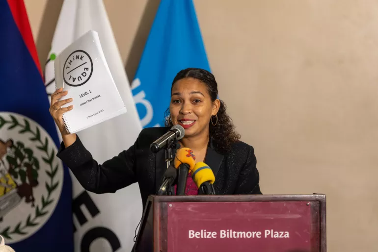 Woman stands with opened book