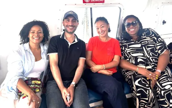 a group of men and women sitting on a boat