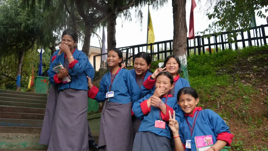 A group of class five students post for a photo as they walk to the school library in Thimphu.
