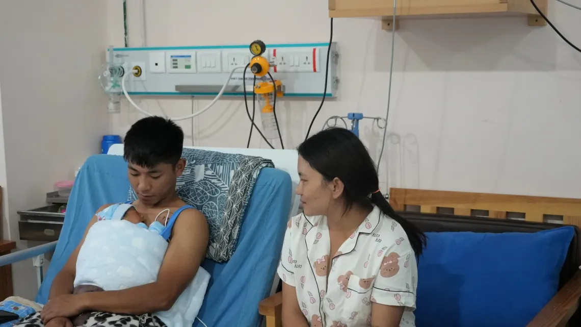 A father provides skin to skin contact to his newborn 
