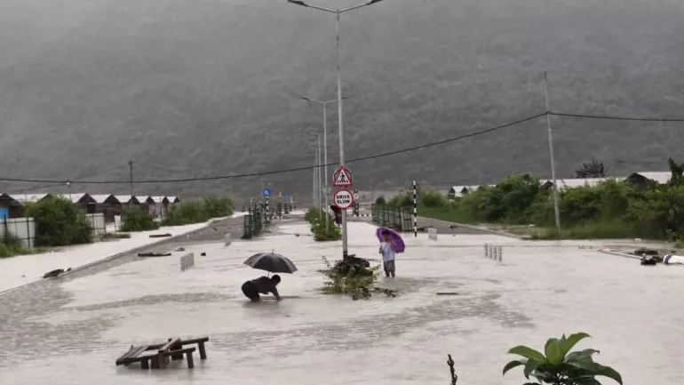 Residents in floodwaters at Amochu Temporary Settlement after heavy rainfall