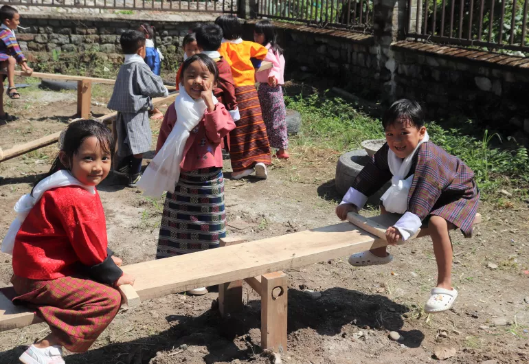 Children playing see-saw