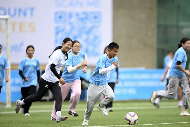 Young people play football during a friendly game 