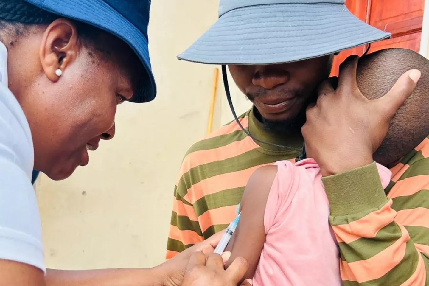 Community health worker vaccinating Ncube's niece in Molapowabojang