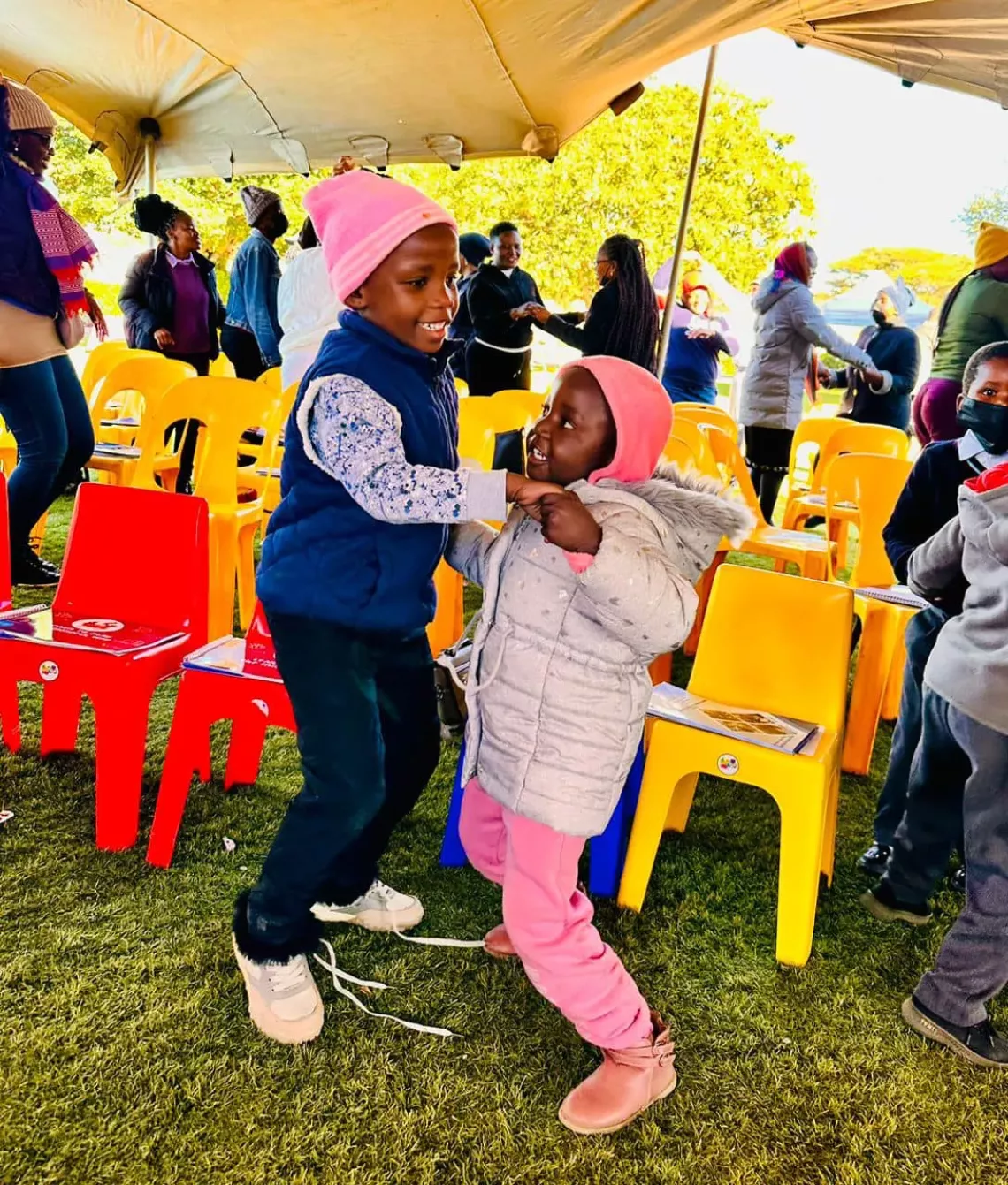 Children playing while holding hands at the commemoration of the first International Day of Play 