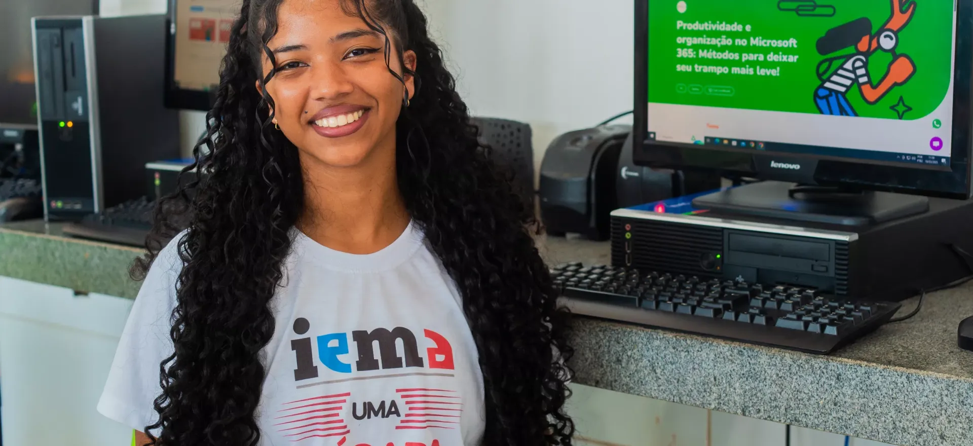 jovem posa para foto em frente a computador