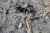 Foto mostra um artefato explosivo em um chão arenoso.