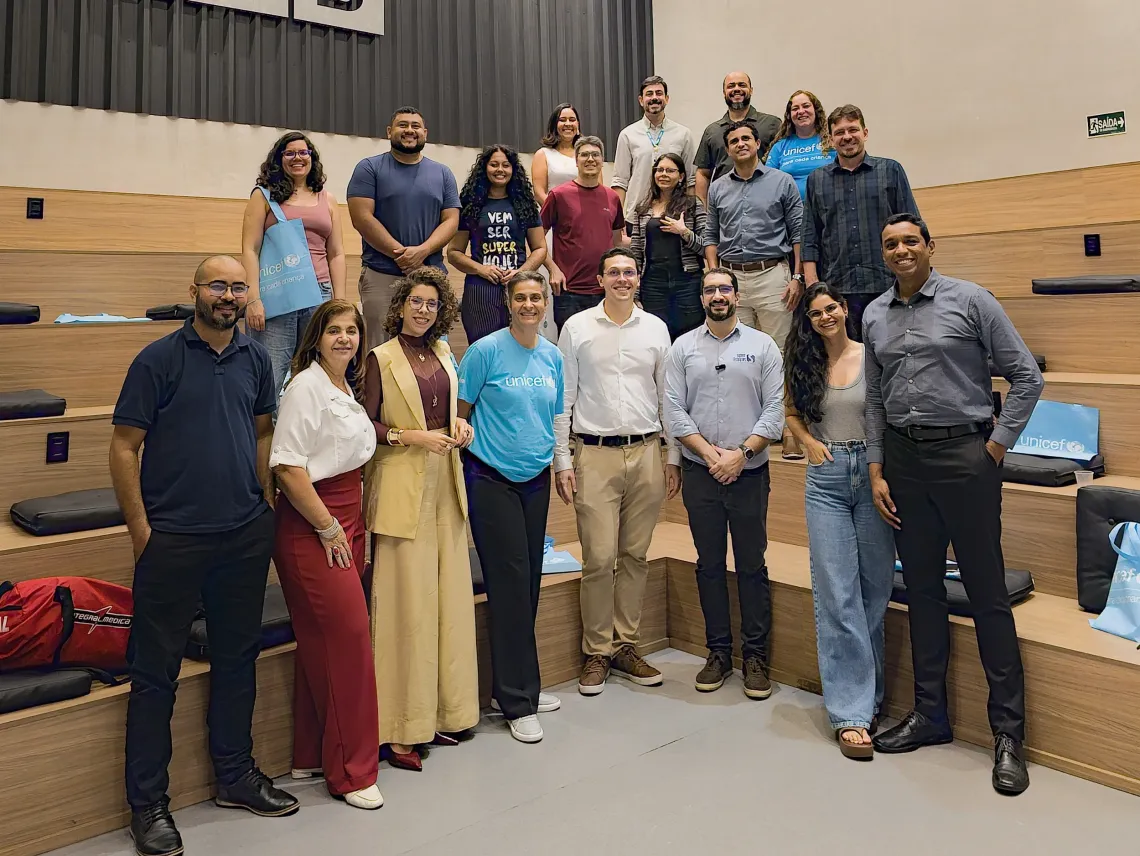 grupo de pessoas posa para foto em escadaria