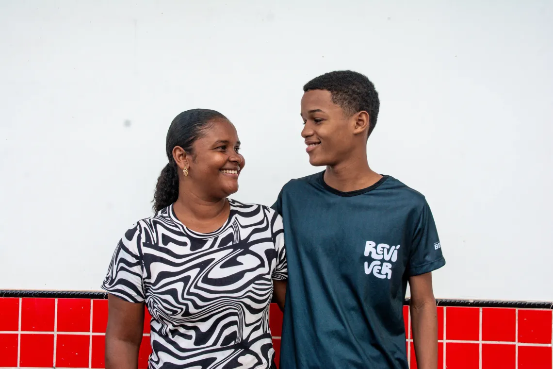 mulher e filho olham um para o outro e posam para foto