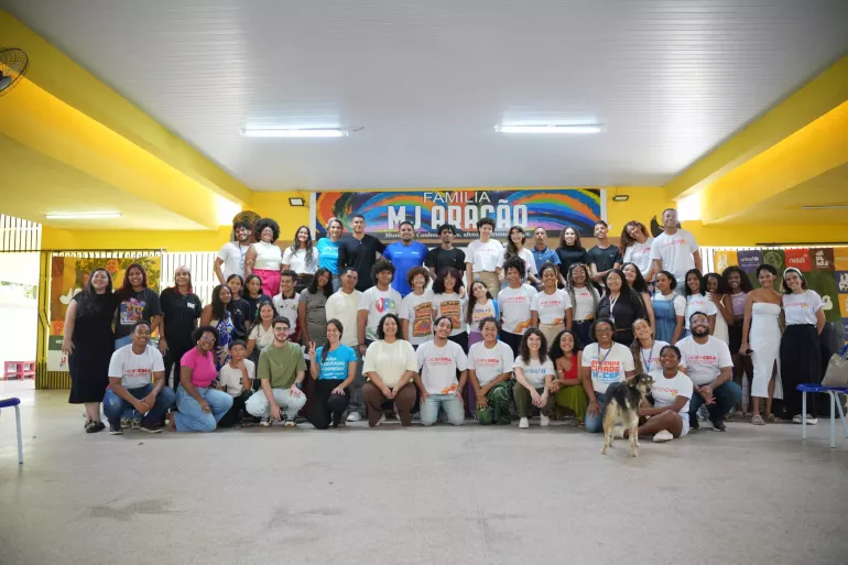 grupo de cerca de 30 jovens e adultos posa para foto