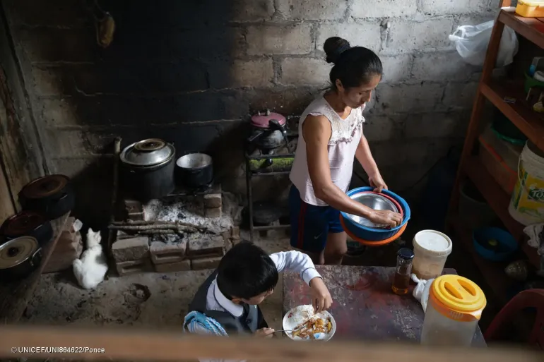 mae e filho vistos de cima em uma cozinha
