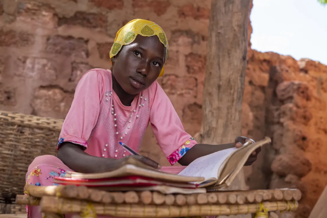 La jeune fille d&eacute;plac&eacute;e Adjara, 11 ans, fait ses devoirs chez son oncle &agrave; D&eacute;doudou, Burkina Faso.