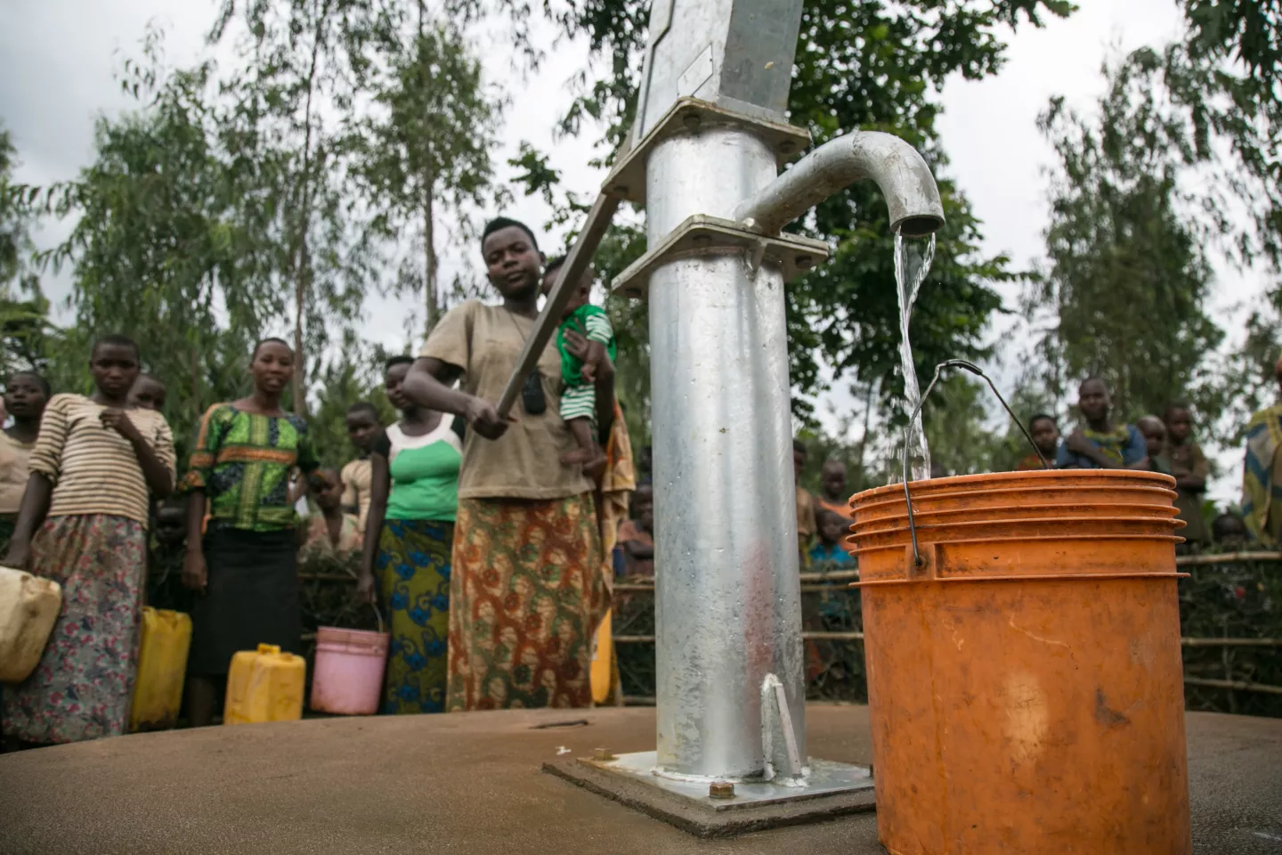 People pump water out of water point, Burundi. 