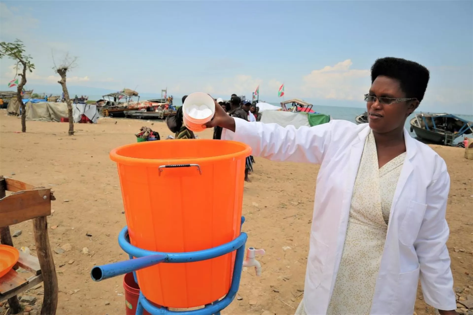 At the Rumonge Port, a health worker prepares the hand-washing device for incoming travelers from DRC. 