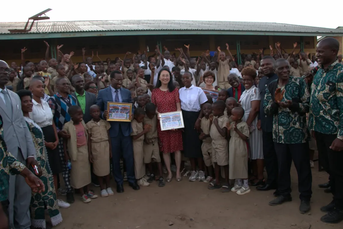 A group photo commemorates the school desk handover ceremony
