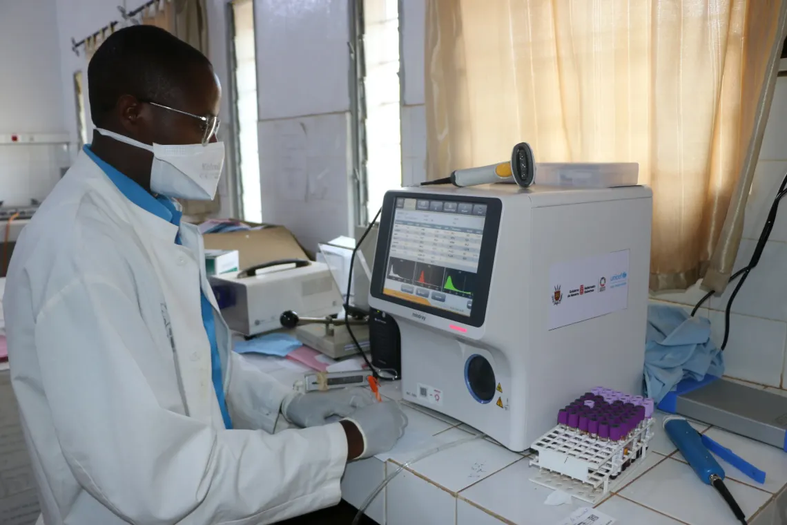 At Rema Hospital in Ruyigi, a lab technician conducting medical tests on patients transferred from the Busuma facility to the emergency room. 