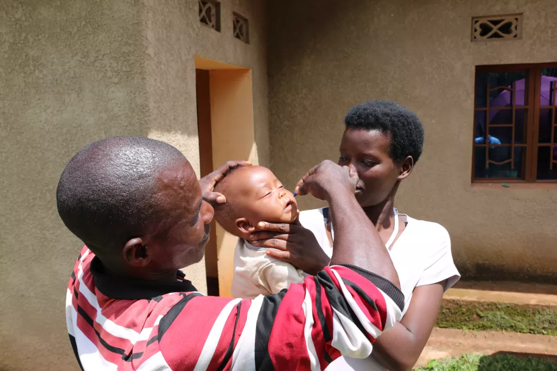 A community health worker administering vitamin A to a child on the Ndago hill, Muramvya province.