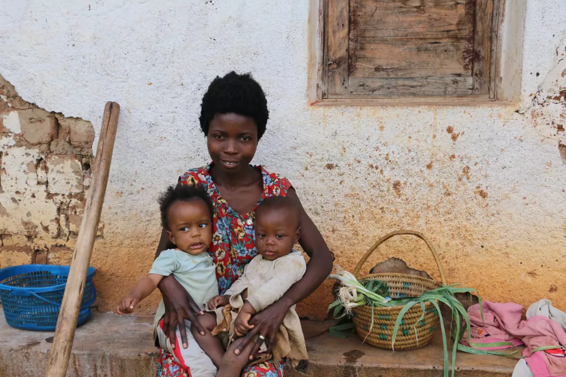 A mother whose twin children have just been given vitamin A supplements, dewormed and screened for malnutrition at Ndago hill in Muramvya province.
