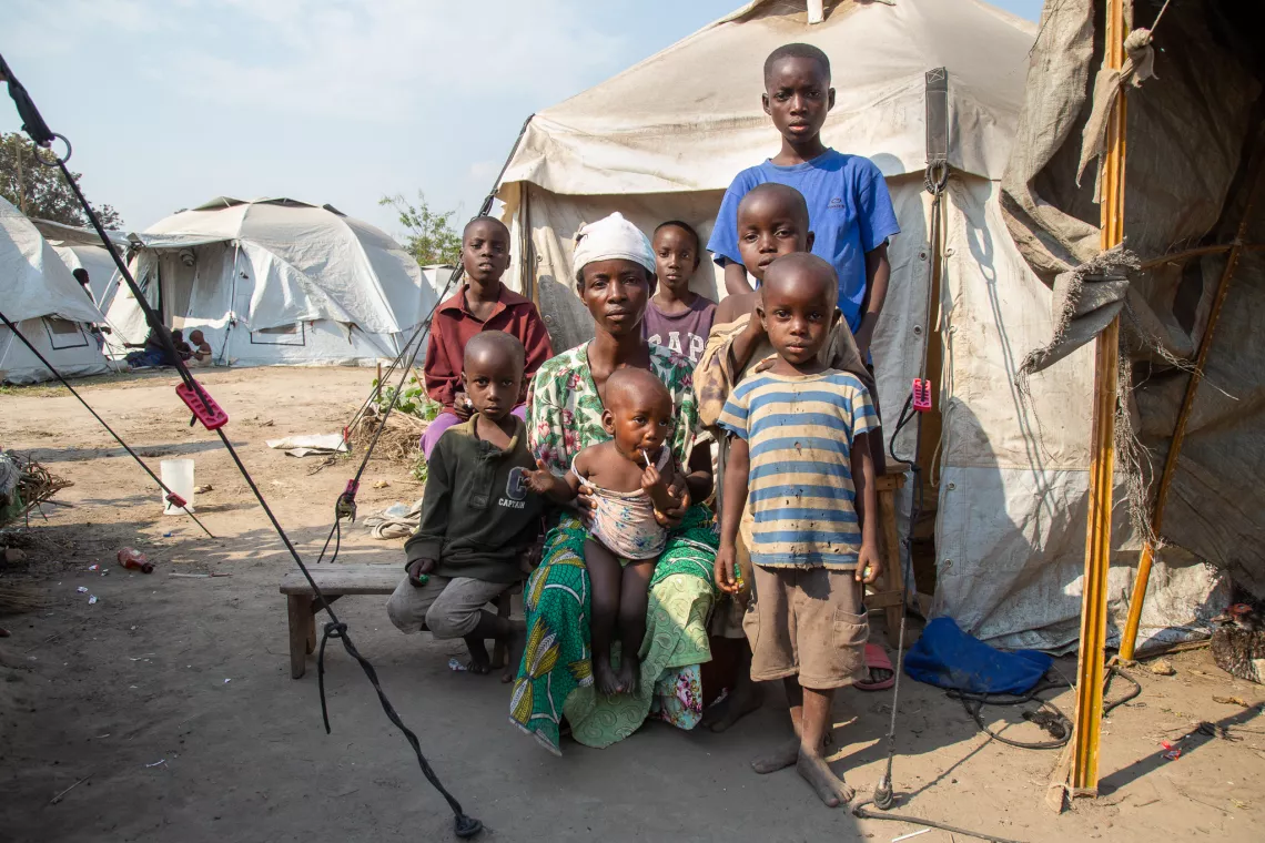 A family posing for a picture in front of their tent in Sobel camp.