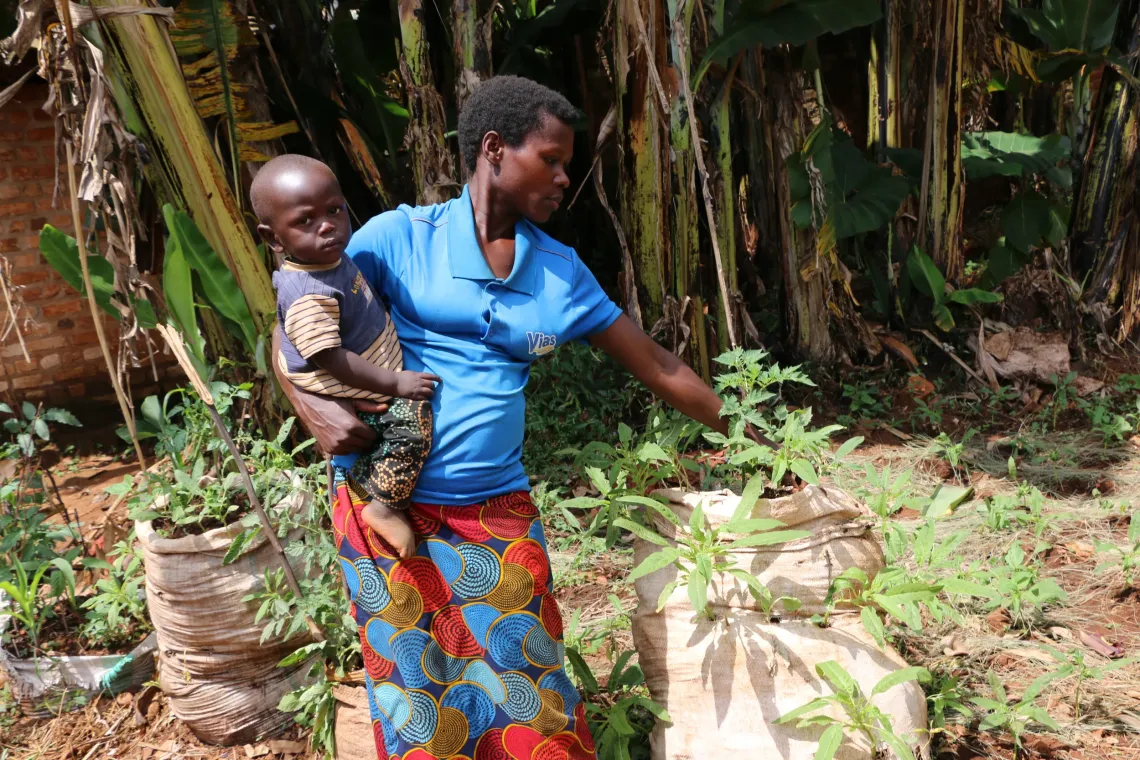 Doroth&eacute;e, who lives near the Musenyi Excellence School, proudly shows her sack gardens inspired by the techniques learned from students benefiting from the CREATABLE project