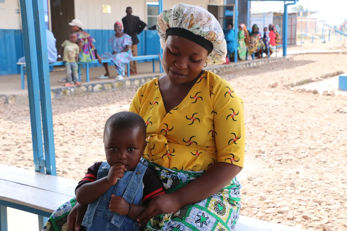 Musenyi 2: Zaidi Kwetemwami Judith, an expectant mother, poses with her first child while waiting for her turn at the clinic.