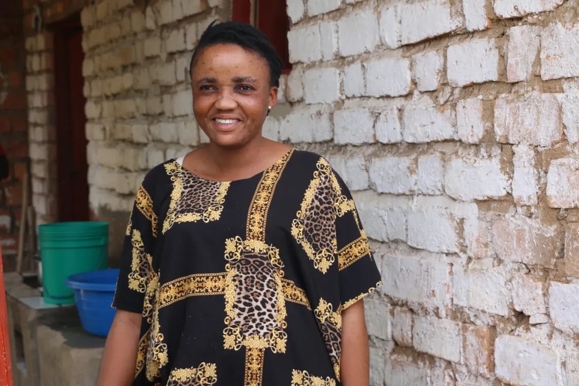 Kahindo Gertrude Ange, a widow and mother of five, is one of the foster caregivers in Musenyi refugee site. She opened her home to a 15-year-old girl who arrived alone after fleeing violence in eastern DRC. 