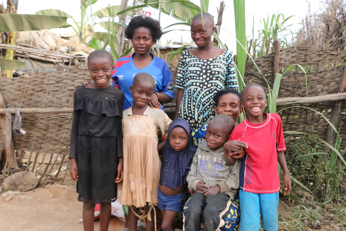 Jacqueline, a foster caregiver in Musenyi refugee site, is pictured with some of the twelve children living under her roof, including both her own children and those she has welcomed into her care. 
