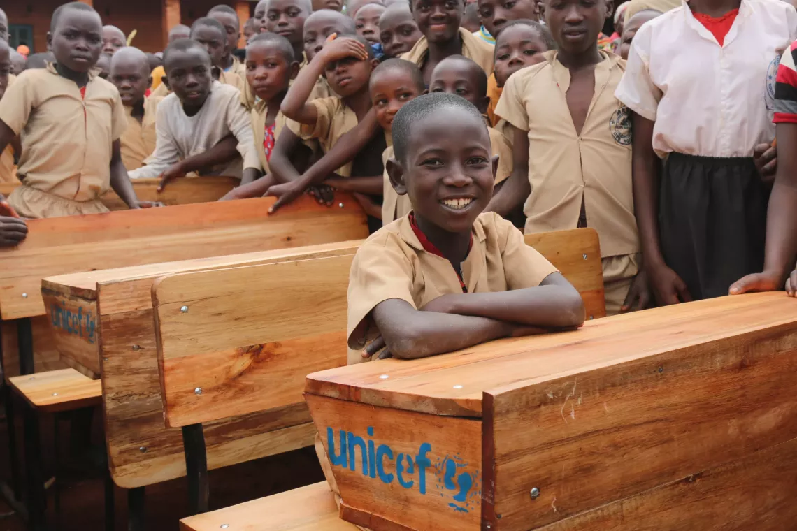 A pupil at Kinyovu fundamental school sits on one of the desks donated by UNICEF.