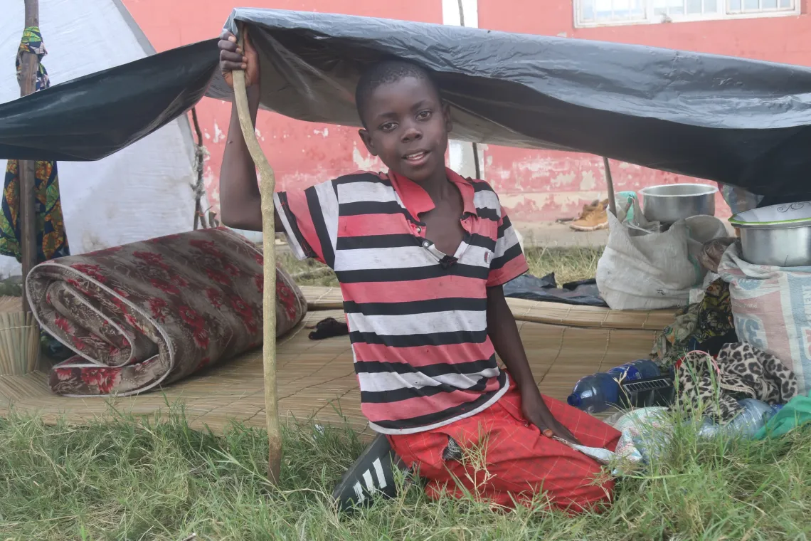 Mugombelwa Michael Morris, under the small makeshift tent where he sleeps.
