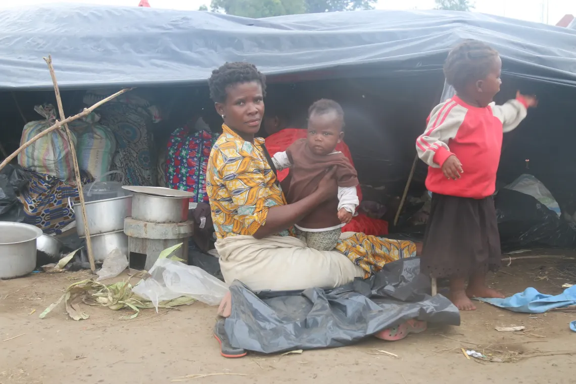 Buhilwa Sukane Christine holding her baby in her arms
