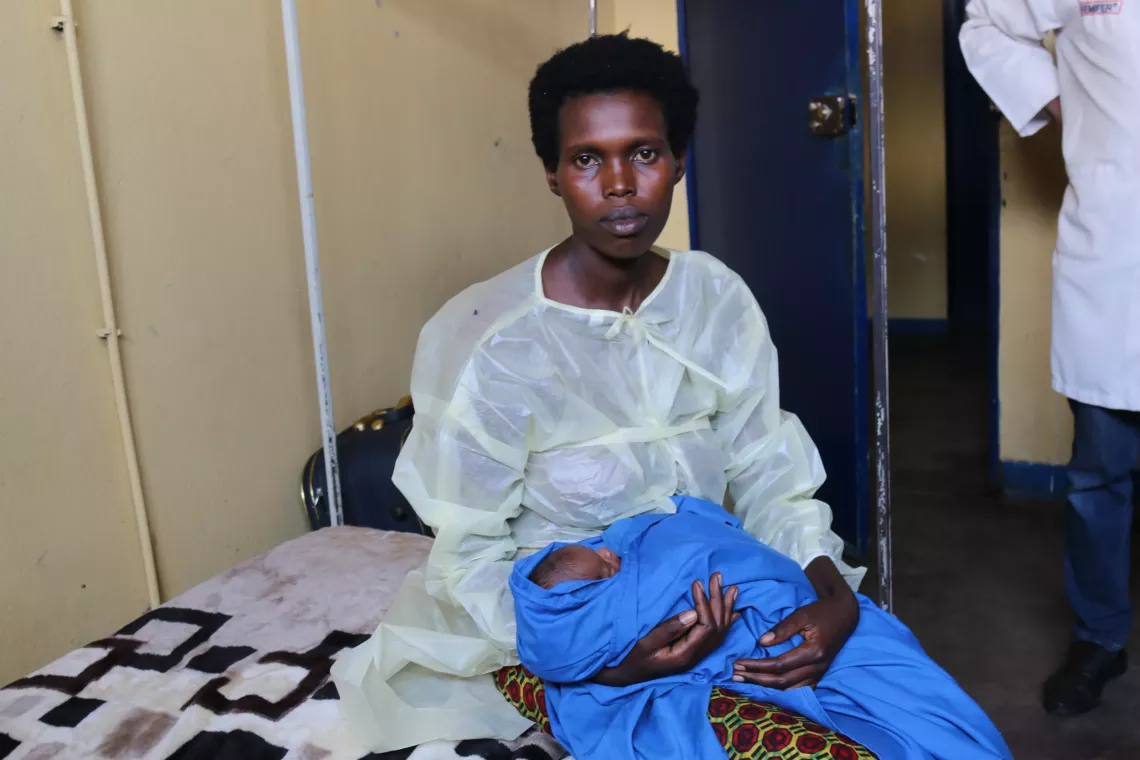   Alice Nshimirimana with her baby, brought out of the incubator on oxygen