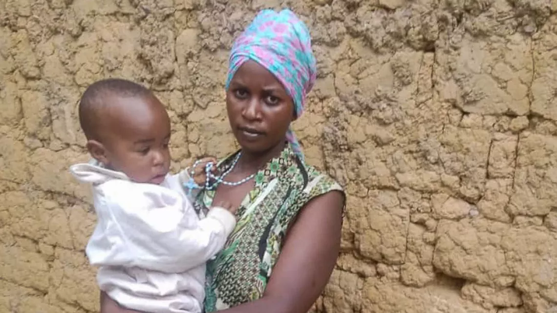 Nad&egrave;ge and her baby boy posing for a photograph.