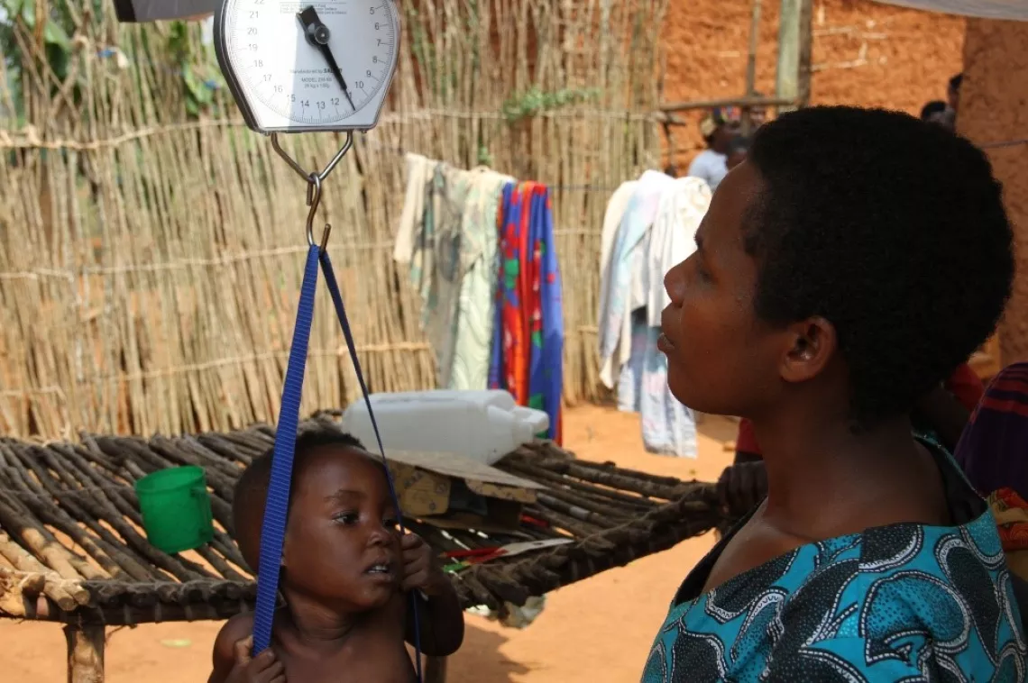 Sonia, a &ldquo;light mother&rdquo; weights a child to make sure that he is not underweight. 