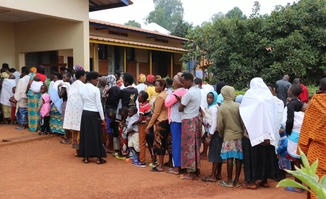 Mothers line up to have their children vaccinated at the Ngozi health center.  