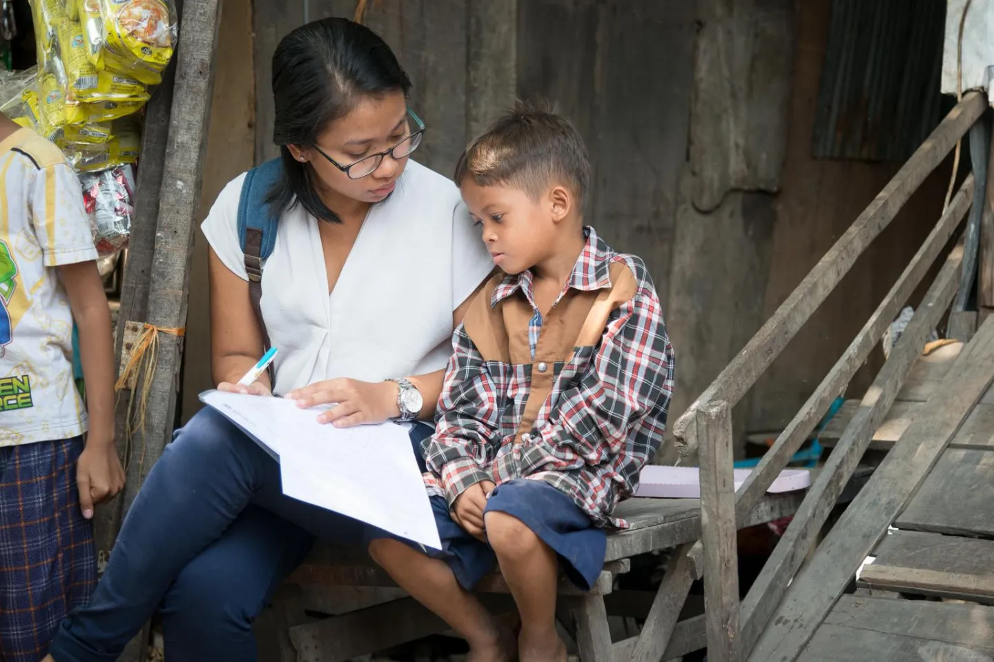 A boy is interviewed by UNICEF volunteer