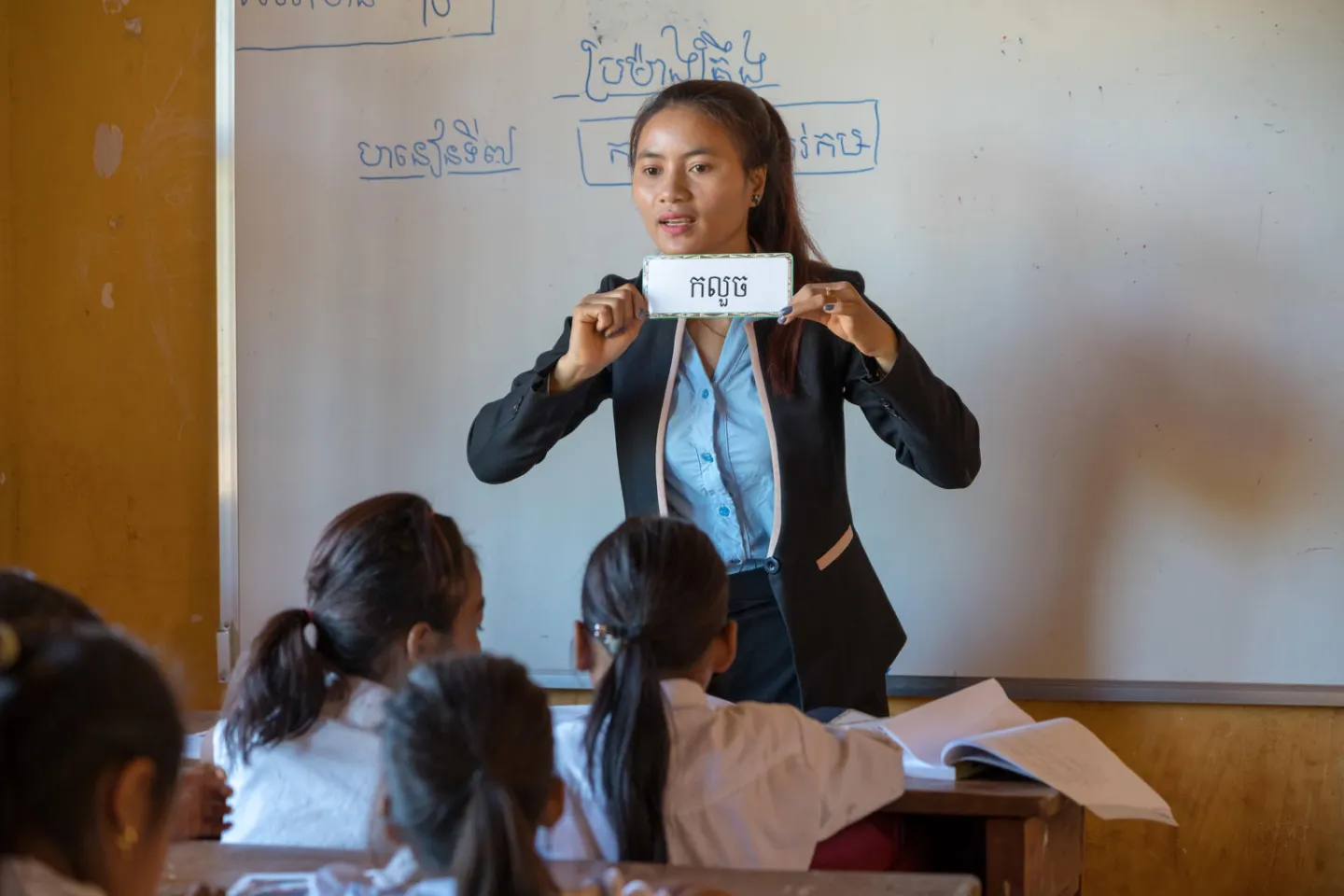 Chea Lach uses flash cards to teach in two languages, Kreung and Khmer