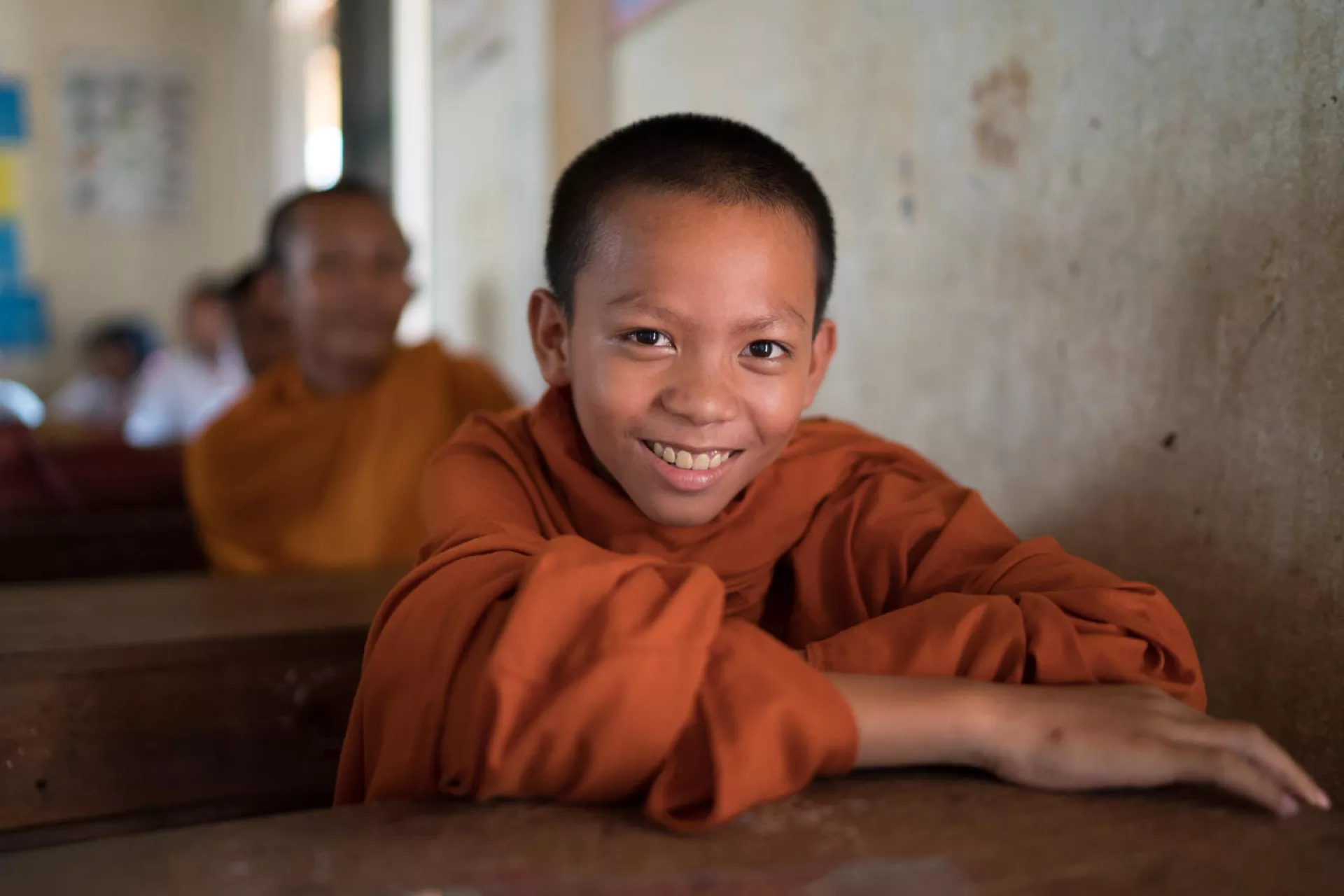 A monk sits in class at Svay Kal Primary School