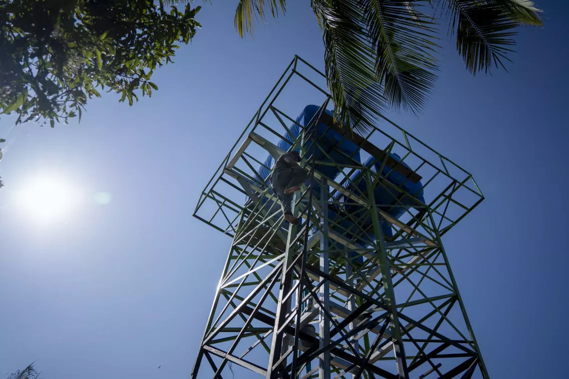 The water tower connected to the community pipe system in Inn Chey Village uses solar power to pump safe, clean to households and community water points 