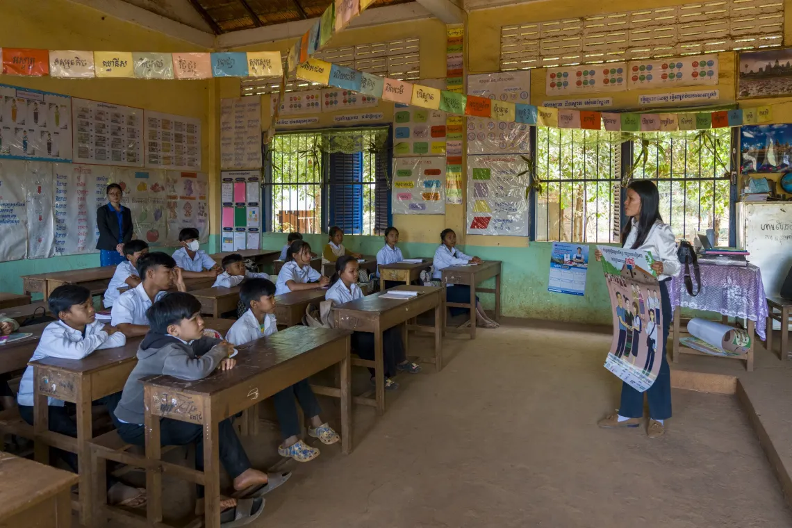 At a primary school in Ratanakiri province, 25-year-old Run Chantou teaches Grade 6 students about the risks of early marriage